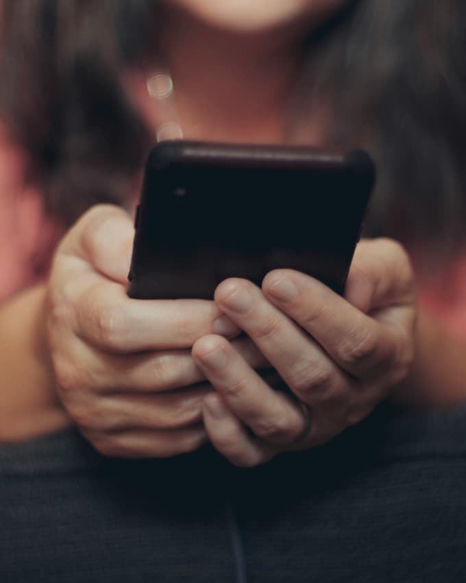 person holding a phone in both hands.
